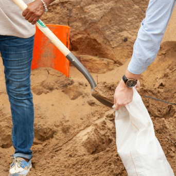 Sand bags being filled by people