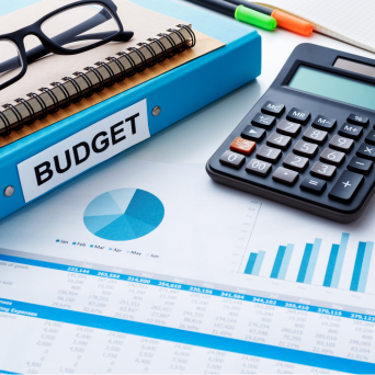 Budget binder with graphs, glasses and office supplies