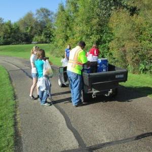 People loading a Gator with refuse
